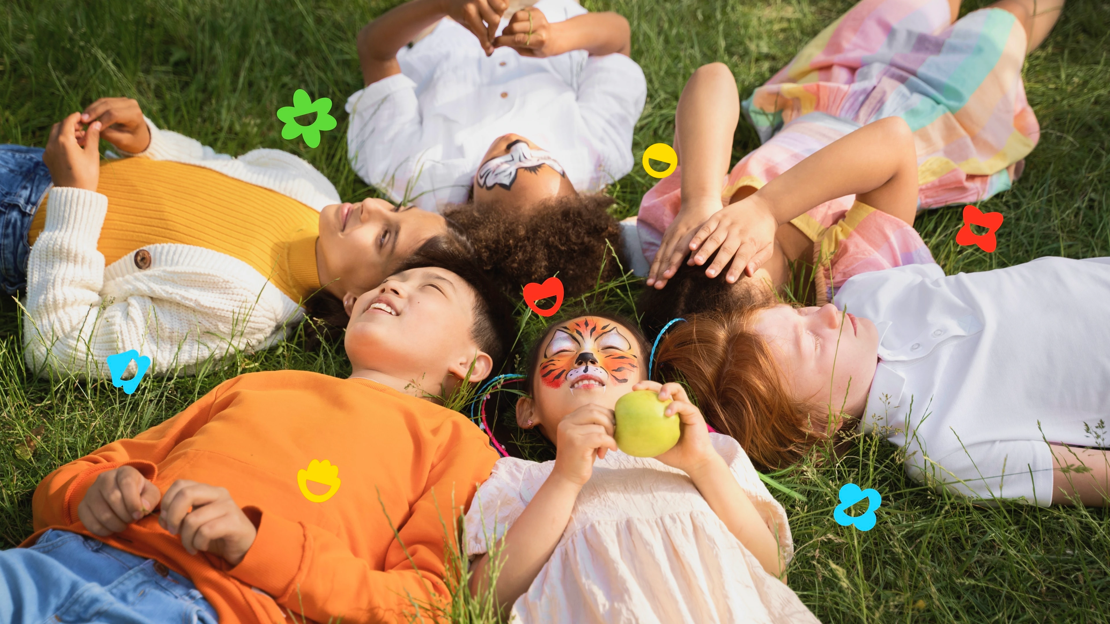 Children lying in grass surrounded by colorful Campsi activity icons