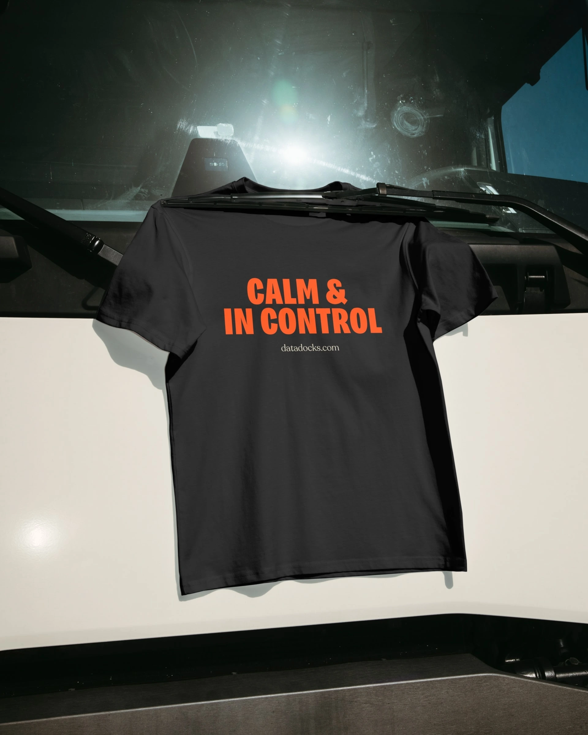 Black DataDocks shirt reading Calm and In Control displayed on a truck