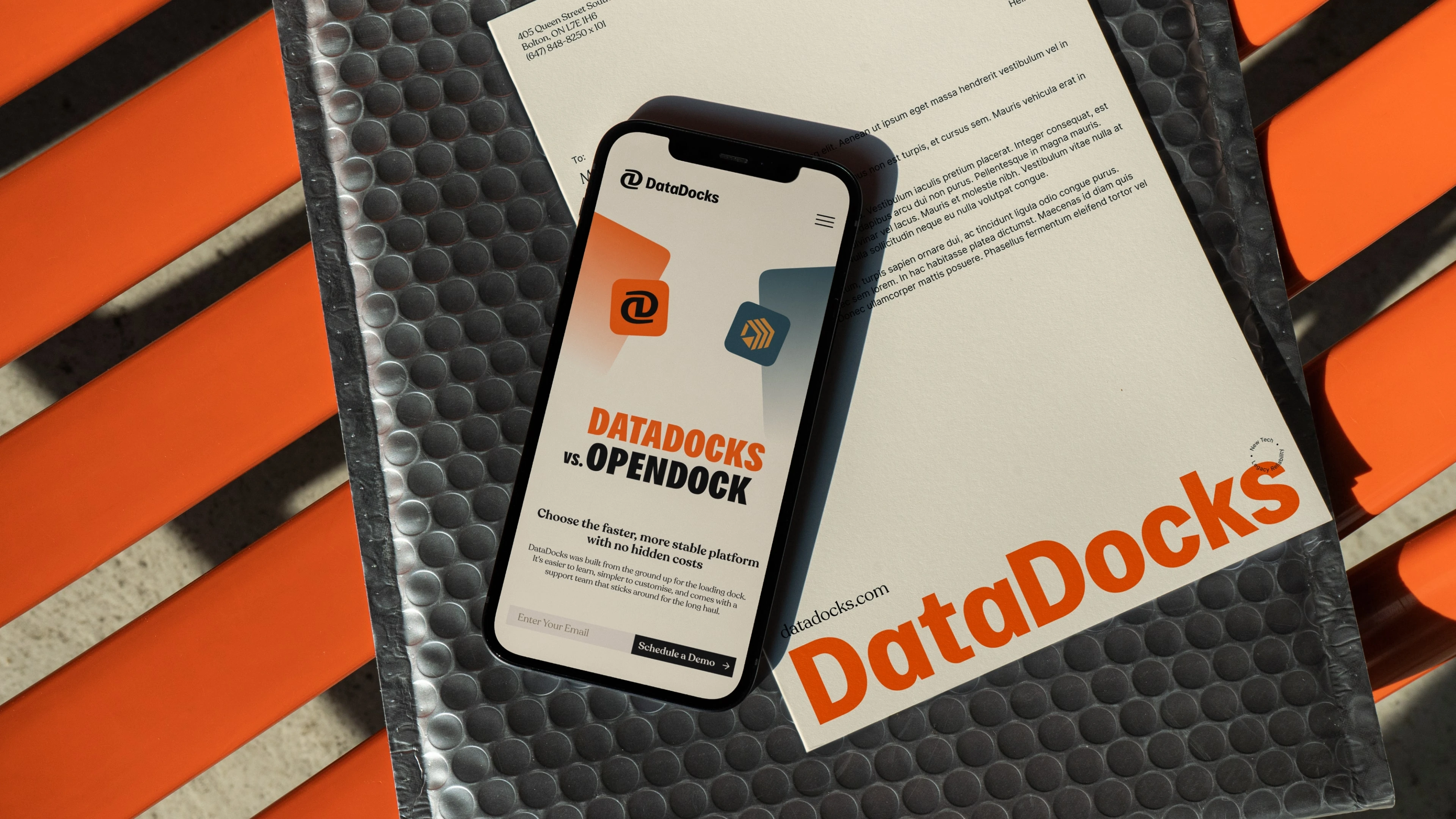 DataDocks comparison page on a phone beside branded letterhead