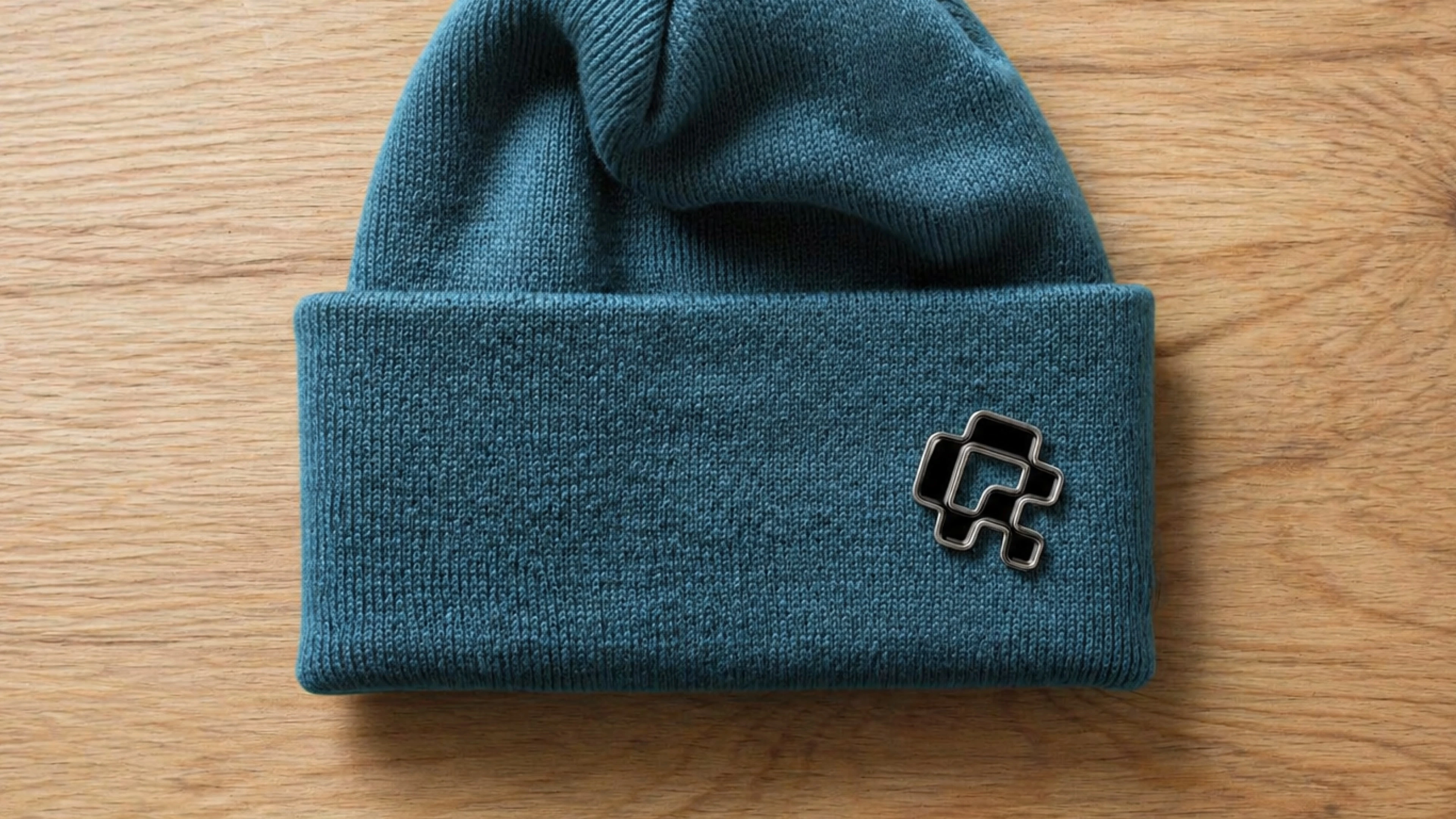 Blue beanie with a black QR-Codes.com symbol pin